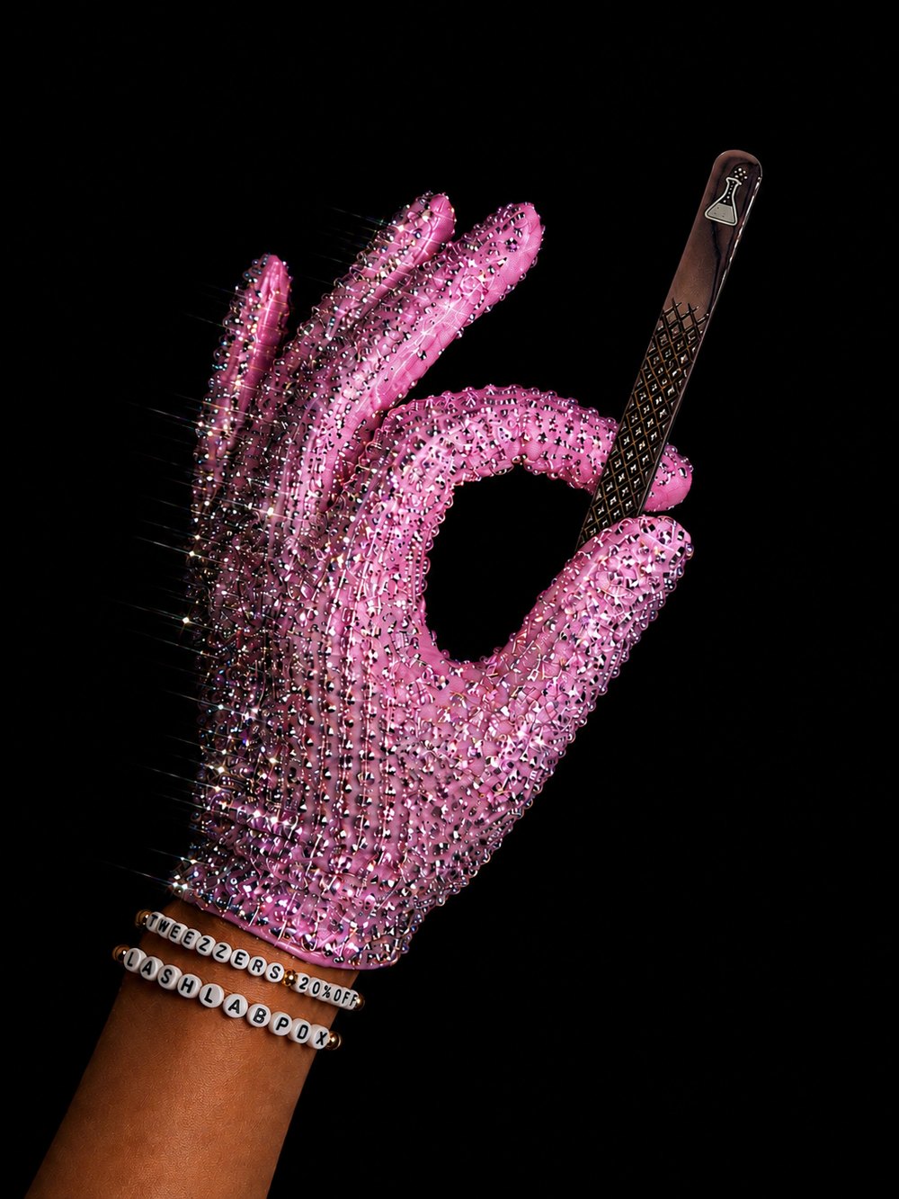 Gloved hand holding lash tweezers — station ready
